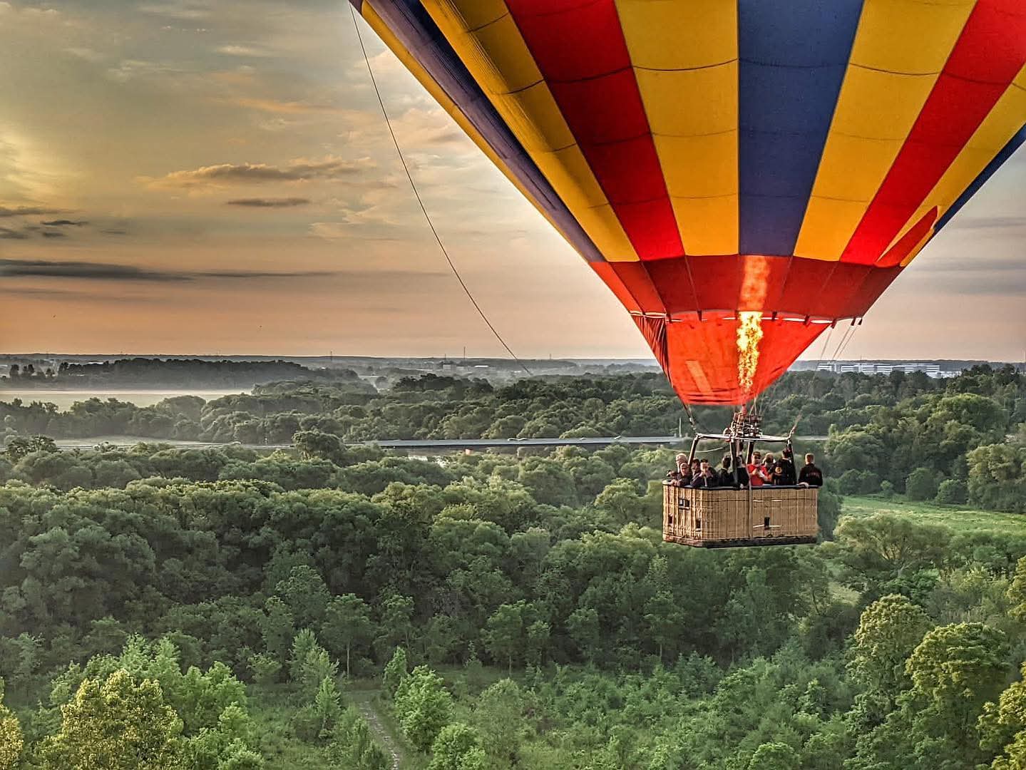 Passengers enjoying a hot air balloon flight over St. Jacobs fields
