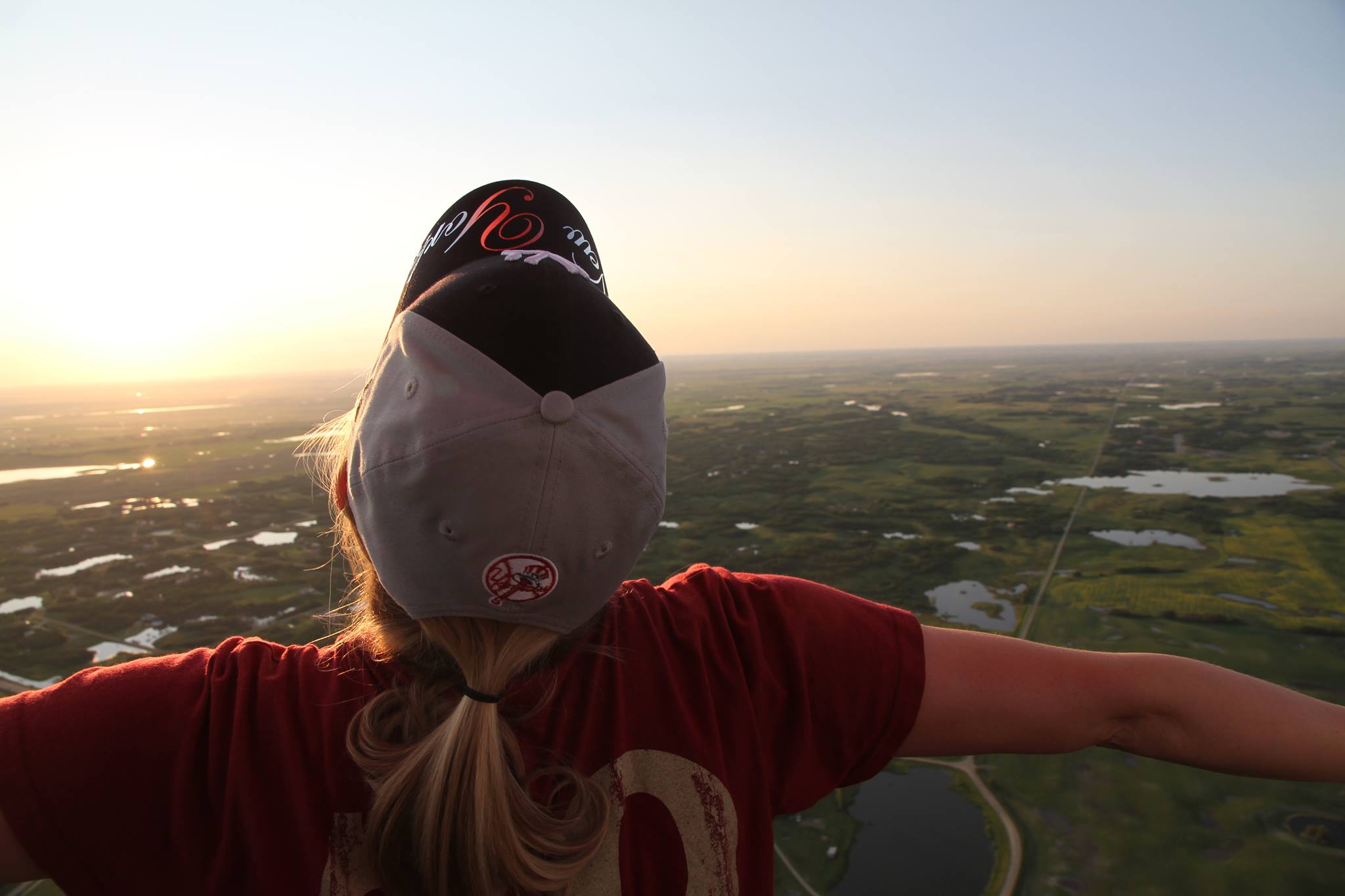 Hot air balloon drifting over rural Ontario during sunrise