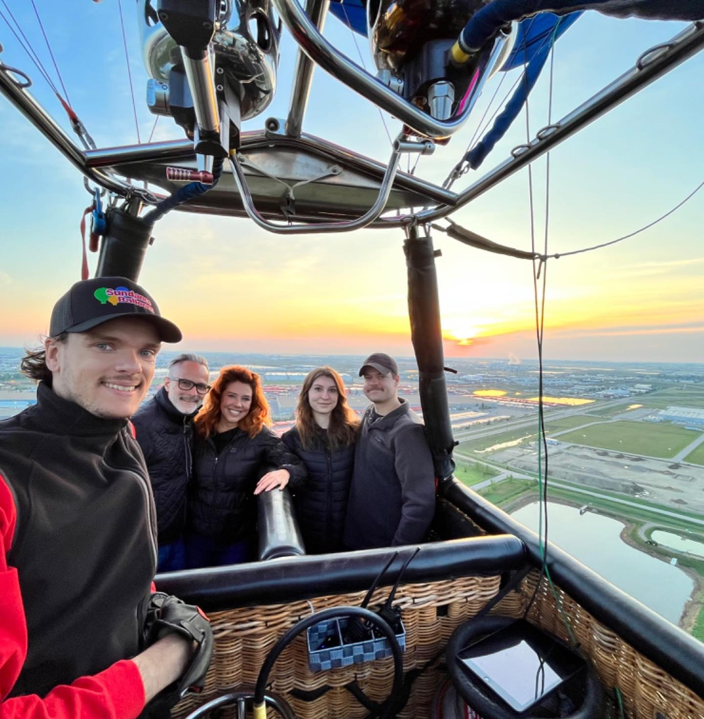 Colourful hot air balloon canopy filling with air before launch