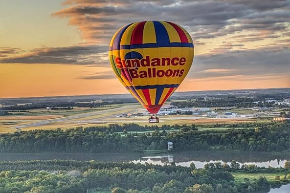Couple from Mississauga leaning on the hot air balloon basket enjoying sunrise views