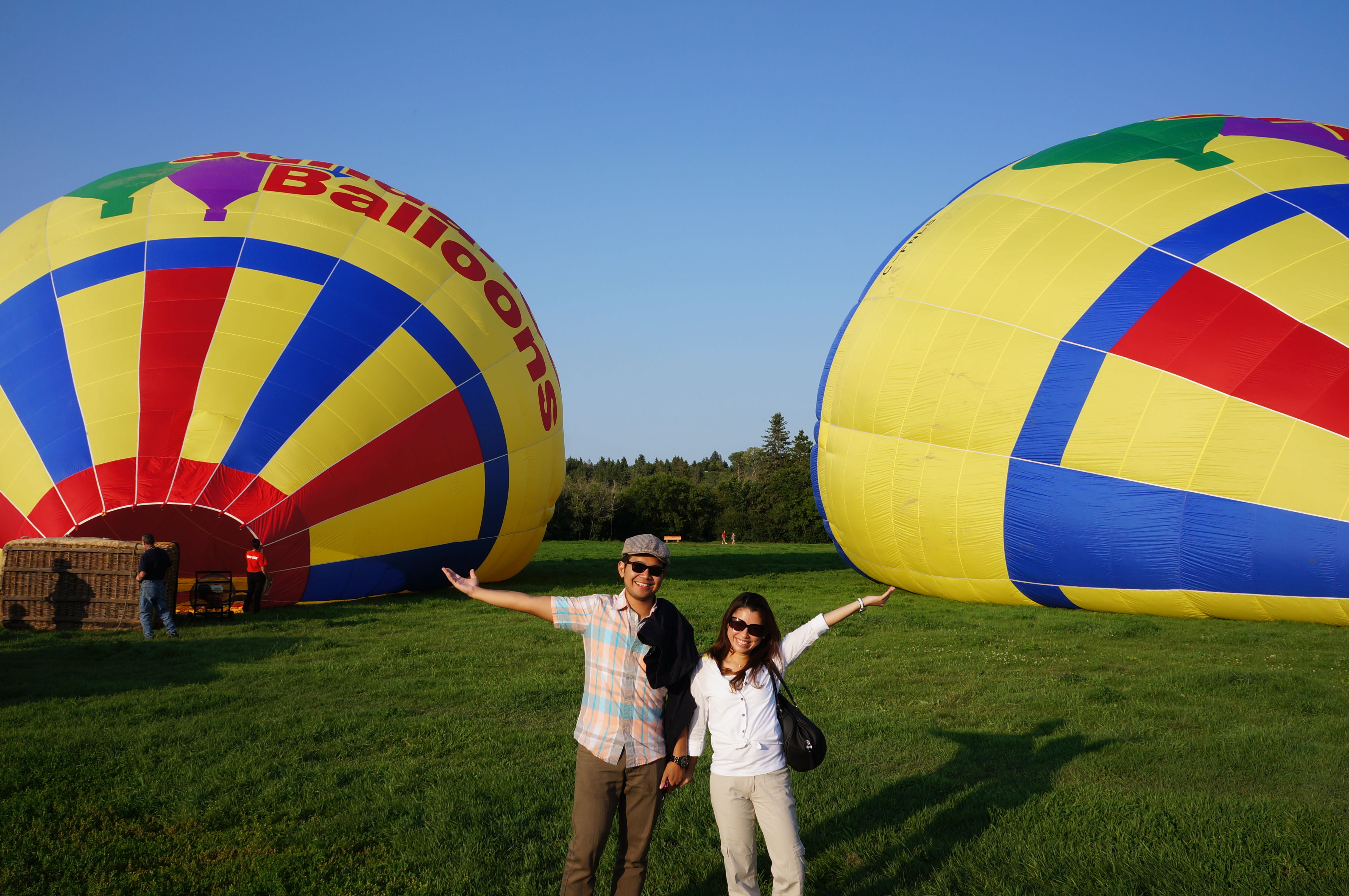 Sundance hot air balloon skimming over calm water with a clear reflection