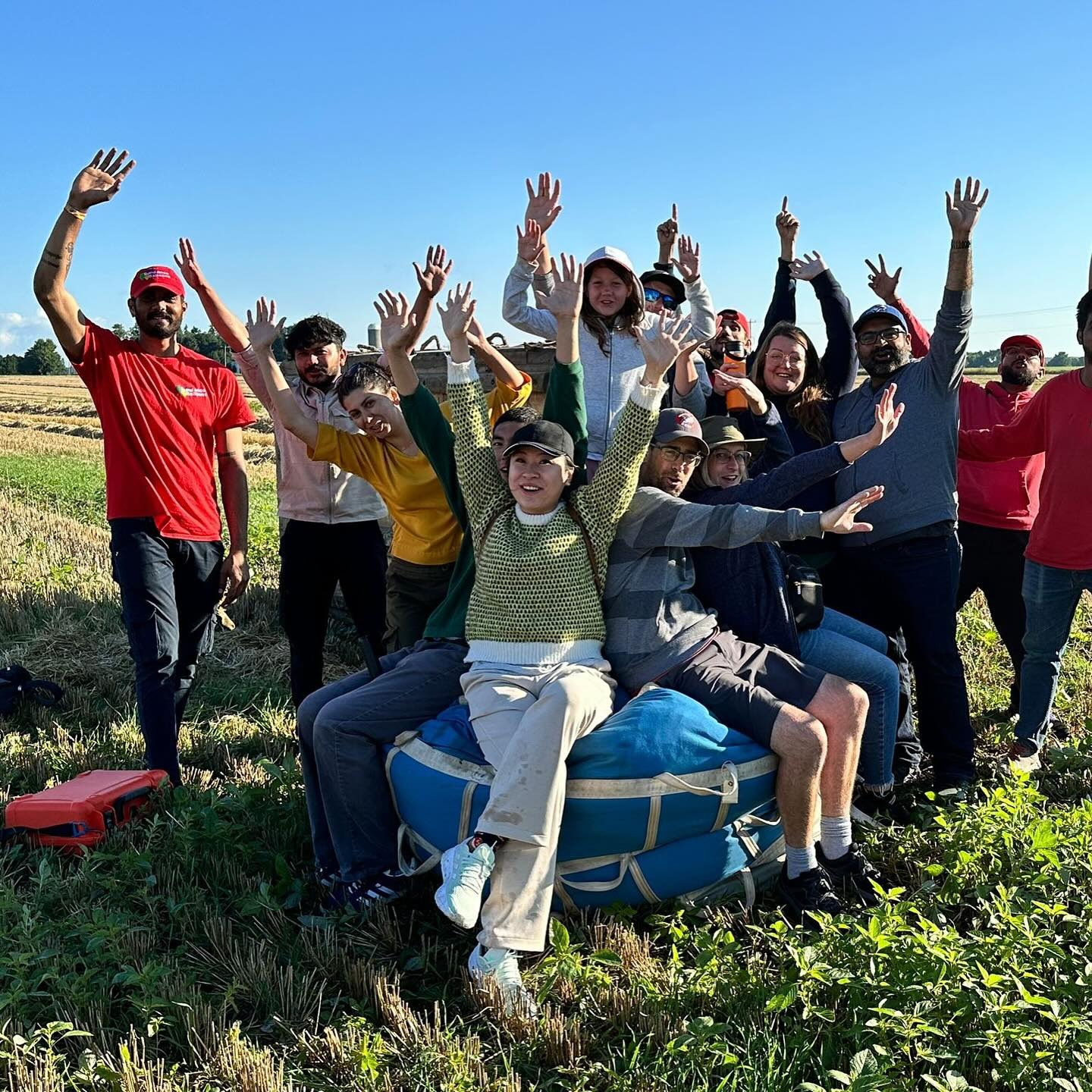Passengers celebrating their hot air balloon flight with a champagne toast after landing